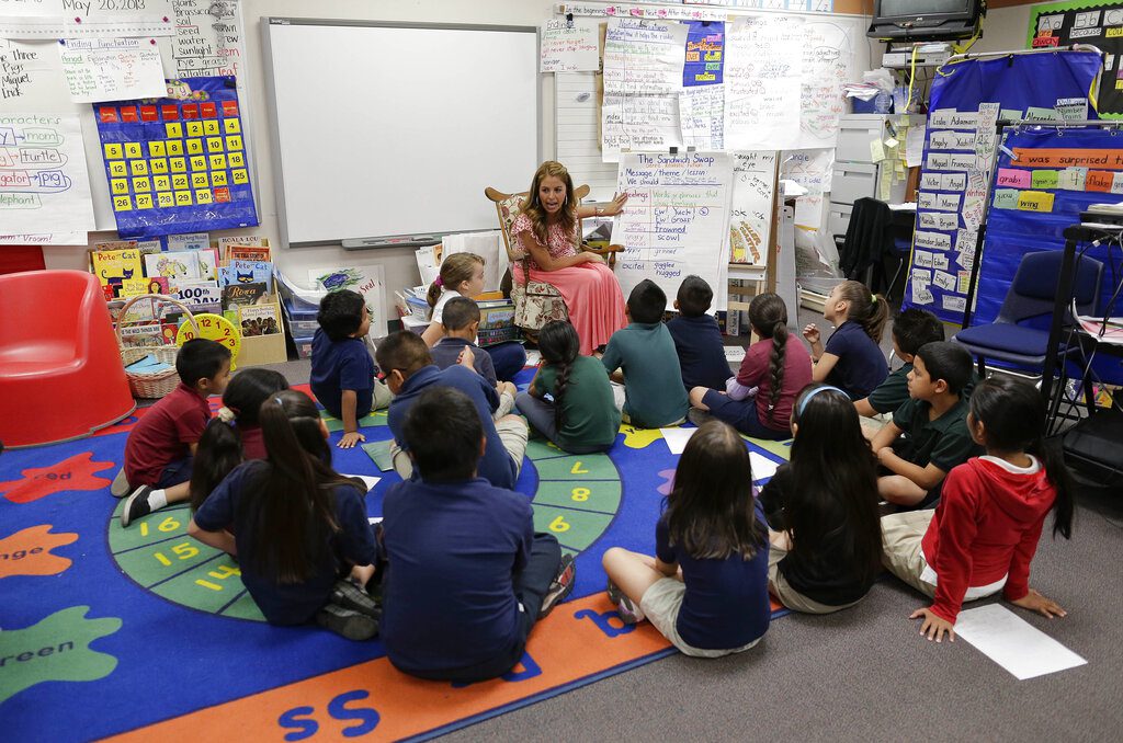 First grade teacher Lisa Cabrera-Terry, center, leads the class in a reading exercise at Jay W. Jeffers Elementary School, in Las Vegas.