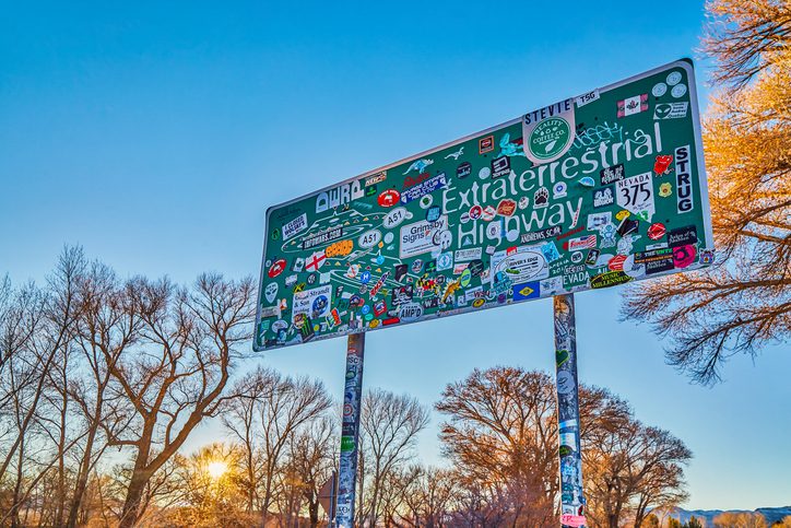 Sign post covered in stickers making the start of the ET Highway near Rachel,Nevada,USA. Rachel is one of the best day trips from Las Vegas.