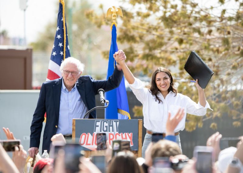 Sen. Bernie Sanders, I-Vt., left, joins Rep. Alexandria Ocasio-Cortez, D-N.Y., on stage before speaking at Fighting Oligarchy: Where We Go From Here rally Thursday, March 20, 2025, in North Las Vegas.