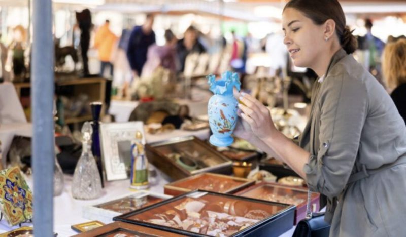 woman checking out wares at antique store