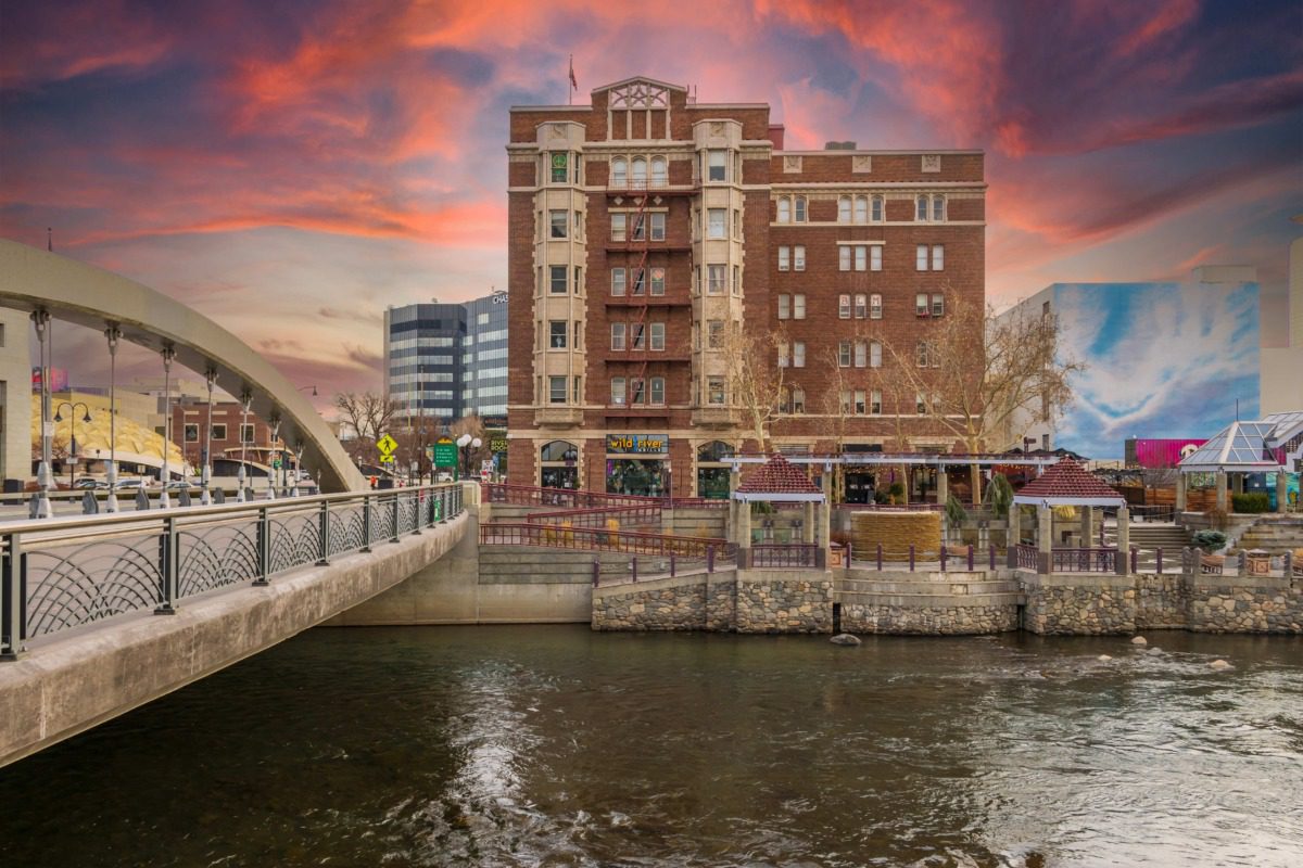 The Truckee River, the Virginia Street Bridge and the Truckee riverwalk with restaurants, retail stores and apartments at sunset in Reno Nevada. Photo courtesy of Marcus E Jones
