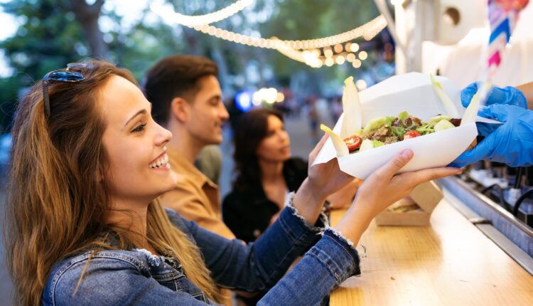 customer grabbing food from a food truck
