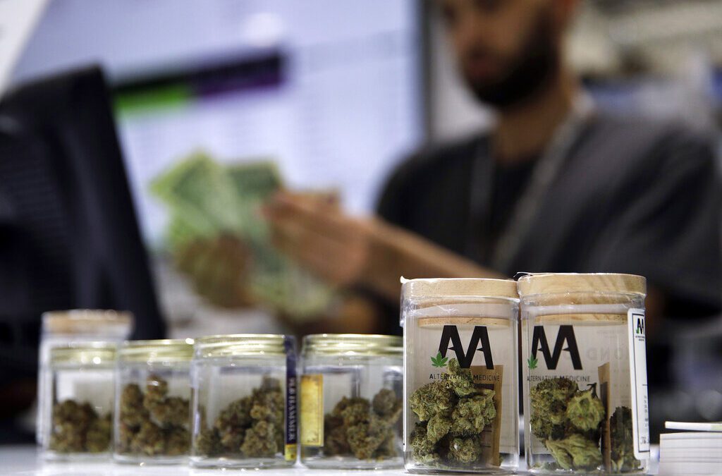 In this July 1, 2017, file photo, a cashier rings up a marijuana sale at the Essence cannabis dispensary in Las Vegas. (AP Photo/John Locher, File)