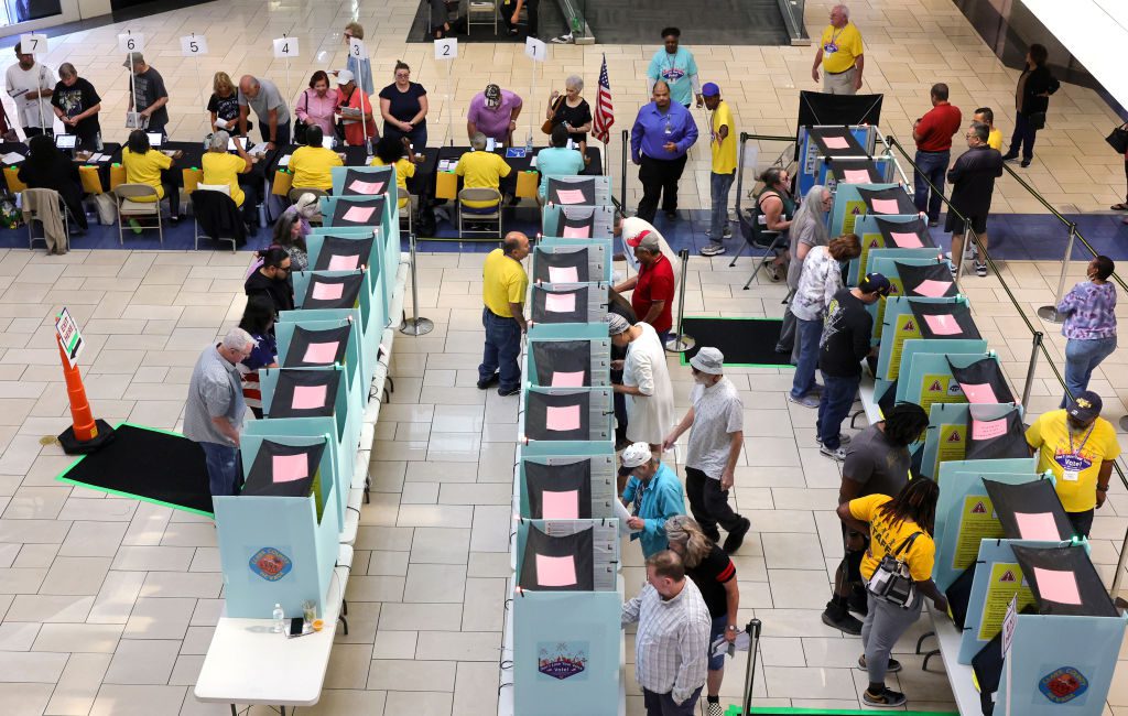 Clark County Election Department poll workers check in voters at a table as people vote at the Meadows Mall on October 21, 2024 in Las Vegas, Nevada. (Ethan Miller/Getty Images)