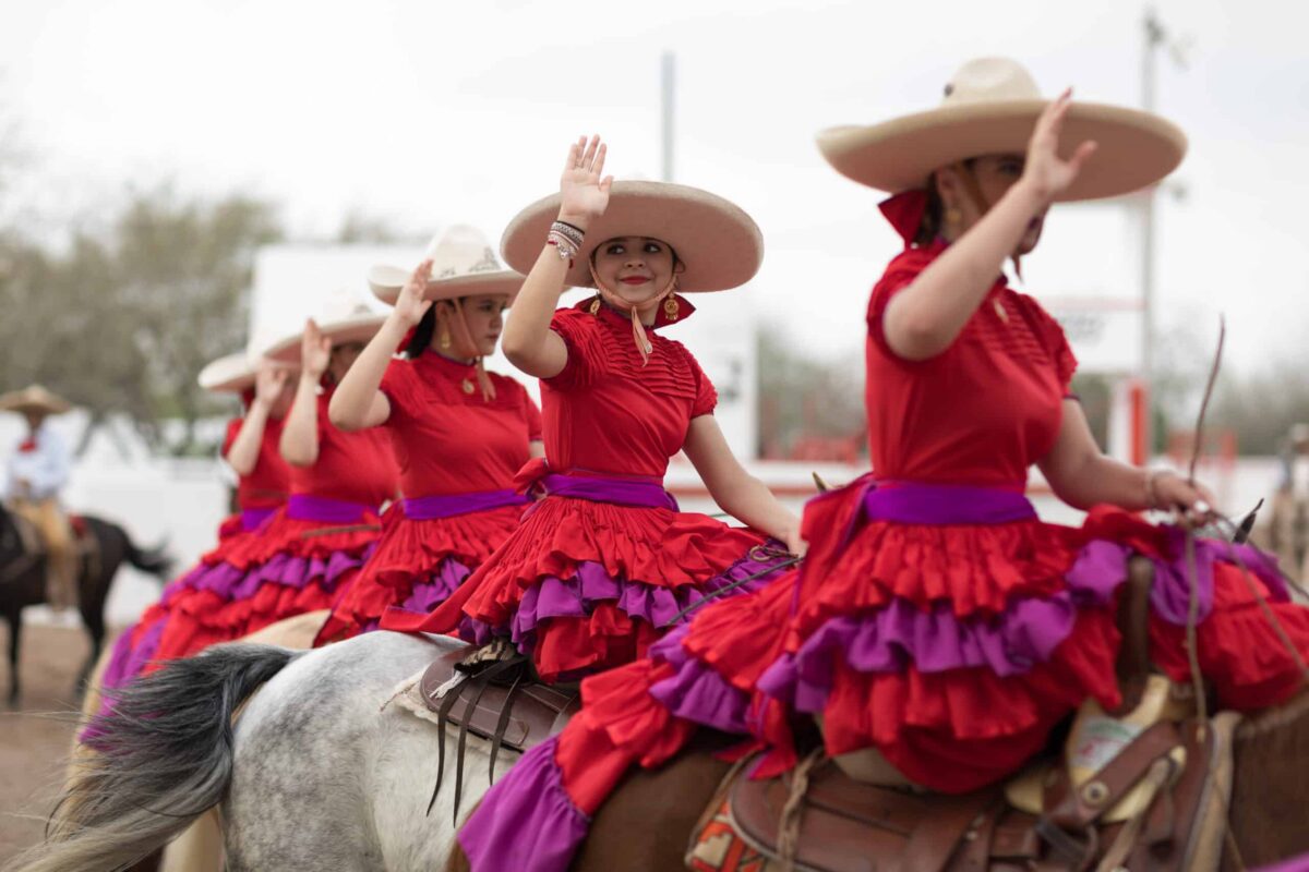 Escaramuzas performing on horseback. (Roberto Galan/Shutterstock)