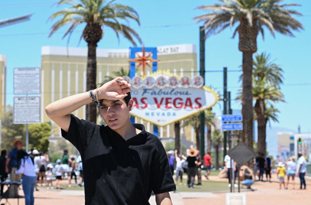 A man walks near the Las Vegas strip during a heatwave in Las Vegas, Nevada on July 7, 2024. (ROBYN BECK/AFP via Getty Images)