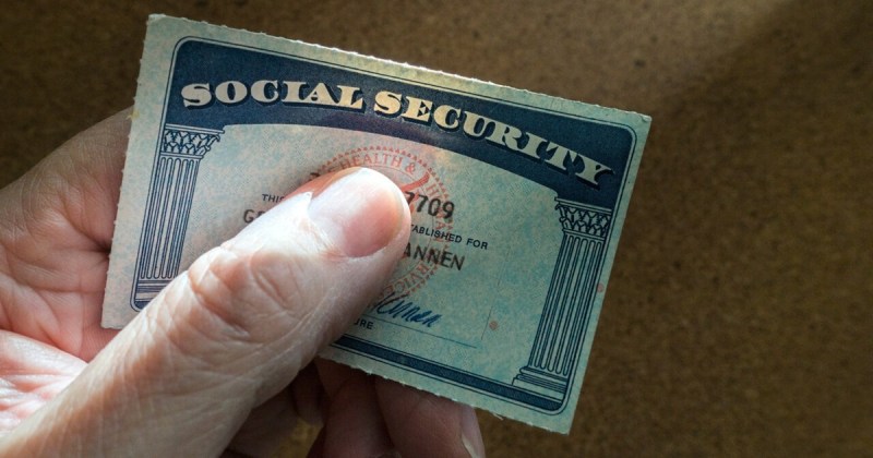 Fingers clutching a Social Security card
