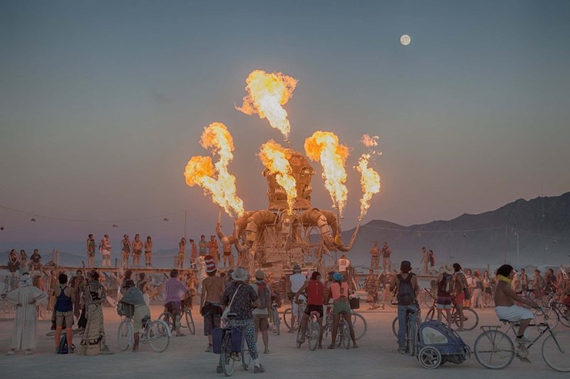 Burners ride bikes around the Black Rock Desert playa to interact with large-scale art during Burning Man