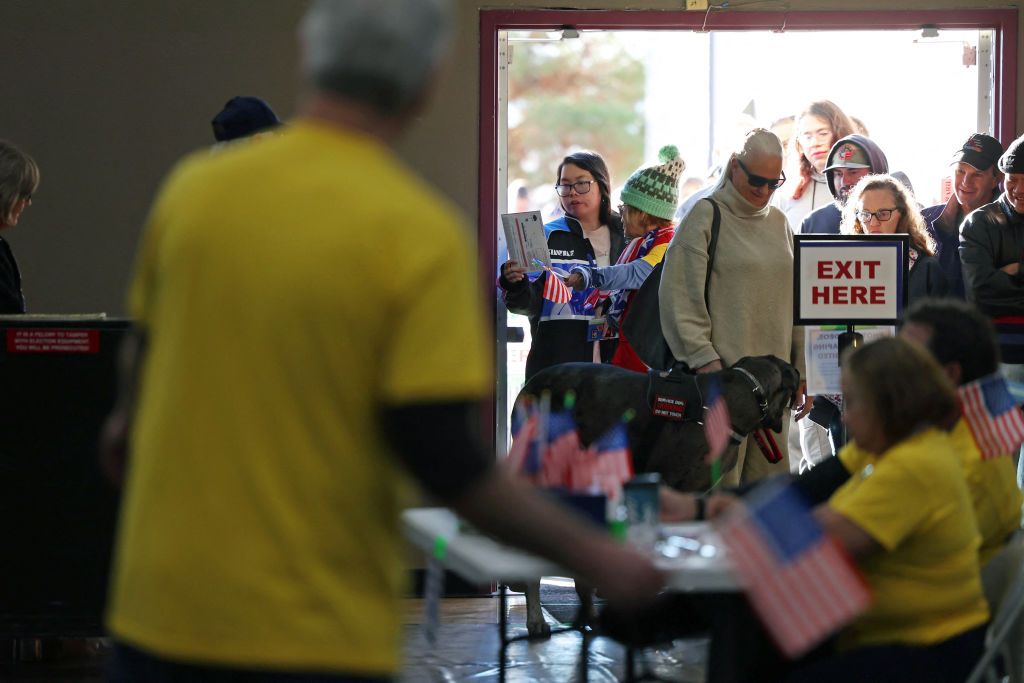 Voters enter a polling location as election workers in yellow shirts assist at a check-in table decorated with American flags.

For all things Nevada elections—from the controversial gubernatorial candidate Danielle Ford to where Lombardo and the other Ford stand on NV Energy’s new demand charge—be sure to follow The Nevadan / El Nevadense.